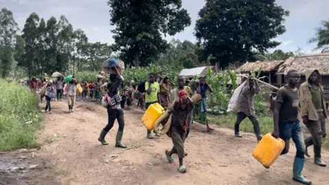 AFP Residents of Bambo in Rutshuru territory, 60 kilometers north of Goma, the capital of North Kivu, eastern Democratic Republic of Congo, flee as the M23 attacked the town on October 26, 2023.