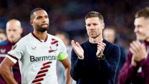 Bayer Leverkusen coach Xabi Alonso and his players look disappointed after losing the Europa League final