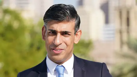 PA Media Rishi Sunak speaking on the roof of the British Embassy in Dubai on Friday