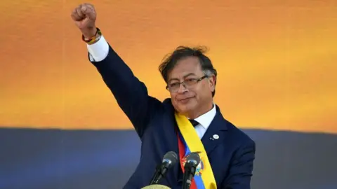 Image shows Gustavo Petro raising his fist