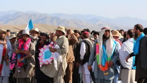 BBC Marchers with a mountainous scenic backdrop in Wardak district, Afghanistan on 14 June 2018