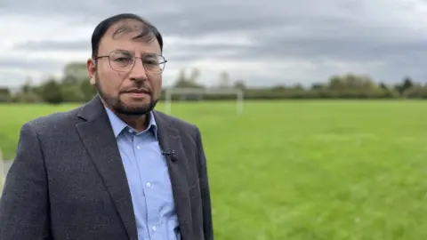 Gabby Colenso/BBC Dr Abdul Shakoor at playing fields near to his former home in Harlow