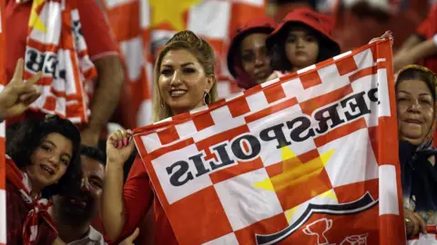 AFP Iranian female fans cheer on Persepolis FC at the Sultan Qaboos Sports Complex in Muscat, Oman, on 22 August 2017