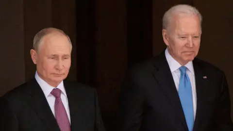 Reuters Vladimir Putin, left, and Joe Biden, right, both dressed in dark business suits