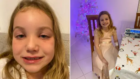 Family photo Maya with swollen face and hooked up to a monitor near a christmas tree