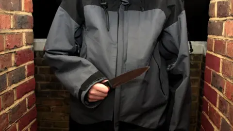 BBC A youth holding a knife