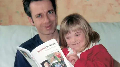 Liz Crowter Steve with Heidi, holding the book