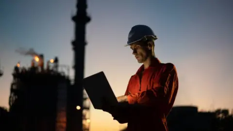 Getty Images oil worker with laptop