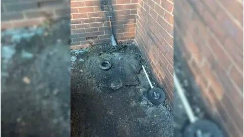 Forever Stars a wall with a burnt out power cable next to a building 