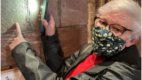 BBC Melba Leonard in mask shows off graffiti