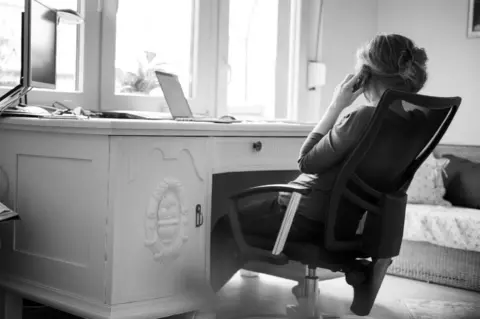 Getty Images A woman answering a telephone vall