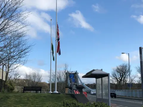 Flags lowered at the Menai Bridge