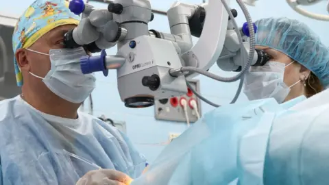 Getty Images Doctor operating on eye