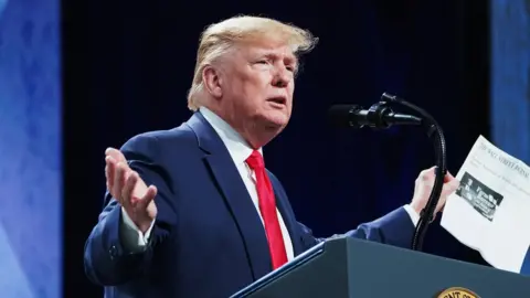 Reuters US President Donald Trump speaking at a podium