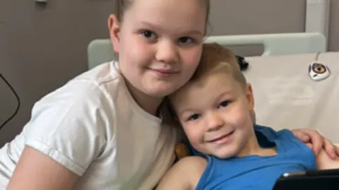 Family Eva hugging Harry in hospital