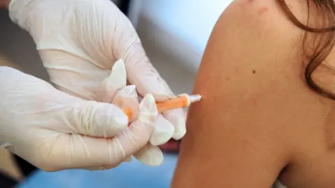 AFP/Getty Images Child getting injection