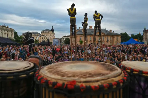 Getty Images Men on stilts from Togo from a troupe called Afuma performing in Kraków, Poland - Saturday 9 July 2022