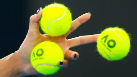 Getty Images A close-up of three tennis balls in Madison Keys' hand.