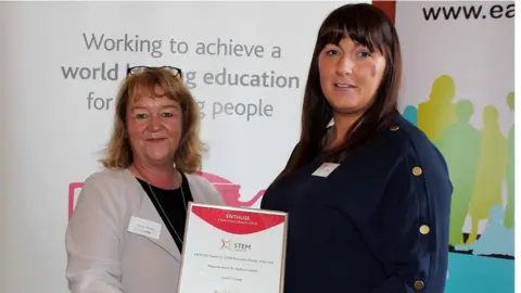 National STEM Learning Network STEM Learning's Hilary Drabble awarding a Northern Ireland ENTHUSE Partnership Secondary School of the Year Award to Lorraine Loughery on behalf of Linseal Secondary School.
