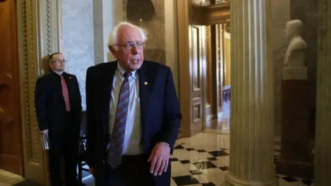 Getty Images Senator Bernie Sanders leaves the Senate chamber on 1 December