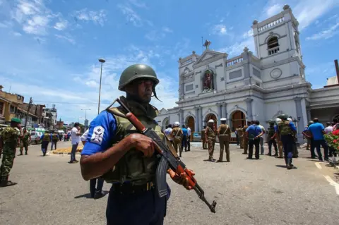 Getty Images Sri Lankan security forces secure the area around St. Anthony's Shrine after an explosion hit St Anthony's Church in Kochchikade