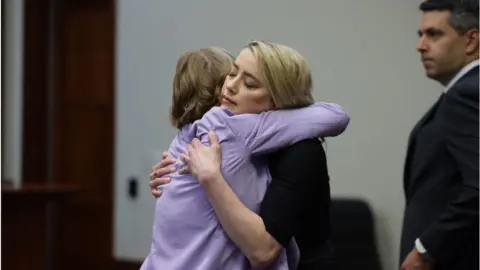 Getty Images Amber Heard hugs her lawyer