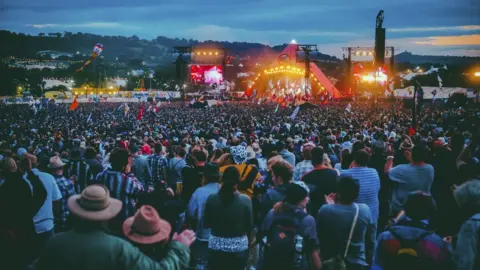 BBC Crowds in front of the Pyramid stage at Glastonbury at night