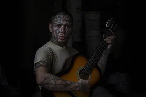 Tariq Zaidi An inmate and former La 18 gang member plays the guitar at the Penal San Francisco Gótera, El Salvador. November 8, 2018.