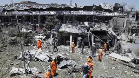 EPA Workers remove debris from a damaged area a day after a suicide bomb attack near foreign embassies in Kabul, Afghanistan, 01 June 2017