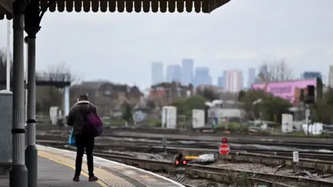 Getty Images A passenger waits for a train