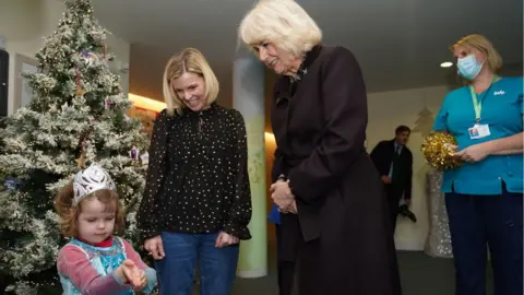 PA Media Queen Camilla greets children and families at the hospice