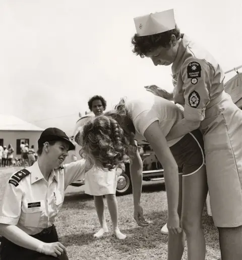 St John Ambulance Volunteers demonstrate the Heimlich manoeuvre