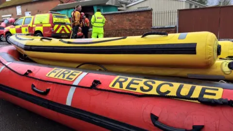 Martin Heath/BBC red and yellow inflatable boat in a village.