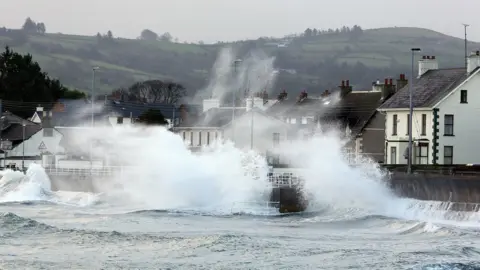 Paul Faith/PA Big waves off the Antrim Coast hitting seawall