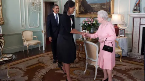 White House/Getty Images Michelle Obama greeting the Queen at Buckingham Palace on 1 April 2009