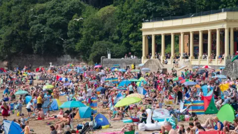 Matthew Horwood People enjoy the sun at Barry Island
