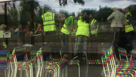 Staff wearing high visibility jackets inside Swiss Cottage leisure centre