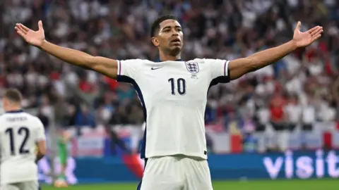 Getty Images England midfielder Jude Bellingham celebrates scoring his team's first goal during the UEFA Euro 2024
