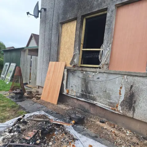 Katrina Archer Serious fire damage as seen from outside a building