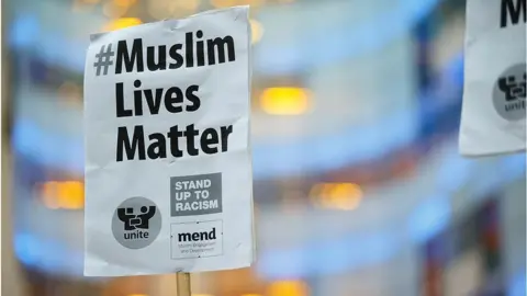 Getty Images Stand up to racism placard