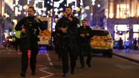 AFP/Getty Images Armed police patrol along Oxford Street