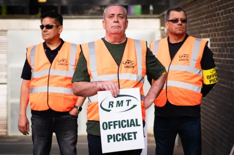 PA Media Rail workers form a picket line at Euston Station in London, as members of the Rail, Maritime and Transport union begin their nationwide strike along with London Underground workers in a bitter dispute over pay, jobs and conditions. Picture date: Tuesday June 21, 2022.