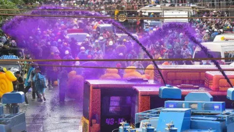 Getty Images Police use a water cannon with chemical-laced water to disperse pro-democracy protesters during an anti-government rally in Bangkok on November 17, 2020