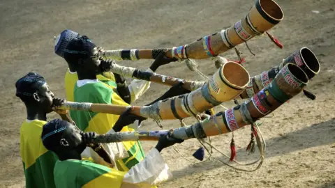 Getty Images Men blow a traditional horn part of a Durbar in Nigeria - 2006
