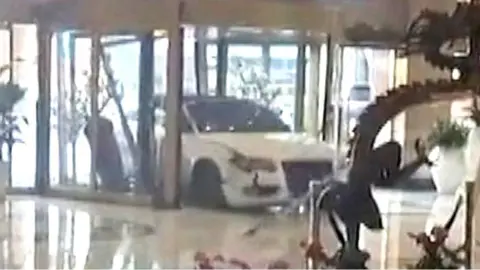 Car smashing through the revolving doors of a hotel in Shanghai