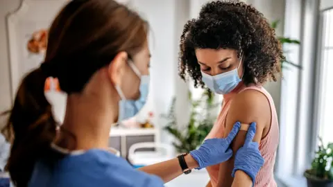 Getty Images Woman being vaccinated