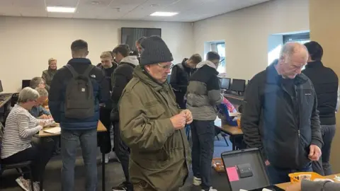 BBC/Daniel Sexton Fans buying tickets at The Gallagher