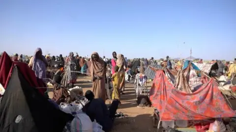 Reuters Displaced people stand among makeshift tents in Tawila, Sudan