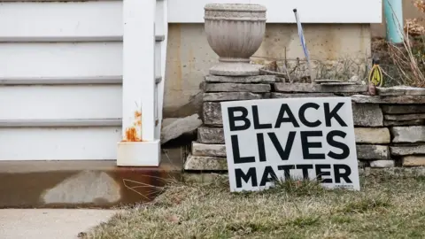 AFP/Getty Images A Black Lives Matter sign sits in a front yard of a house in Evanston, Illinois, on March 16, 2021