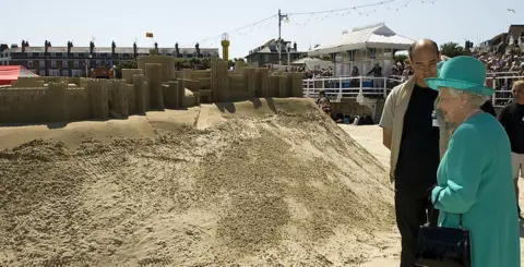 WPA Pool/Getty Images The Queen inspects a specially-made sandcastle shaped like Windsor Castle